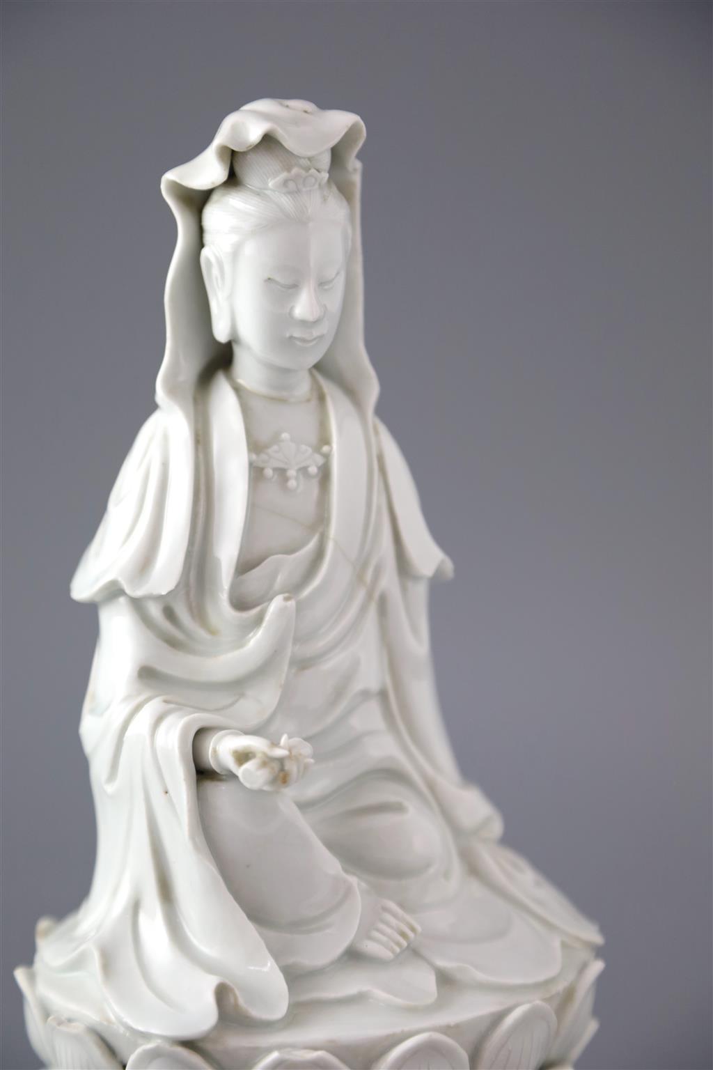 A Chinese Dehua blanc de chine seated figure of Guanyin, 18th/19th century, 25cm high